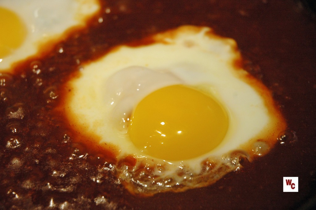 Eggs poached in red sauce